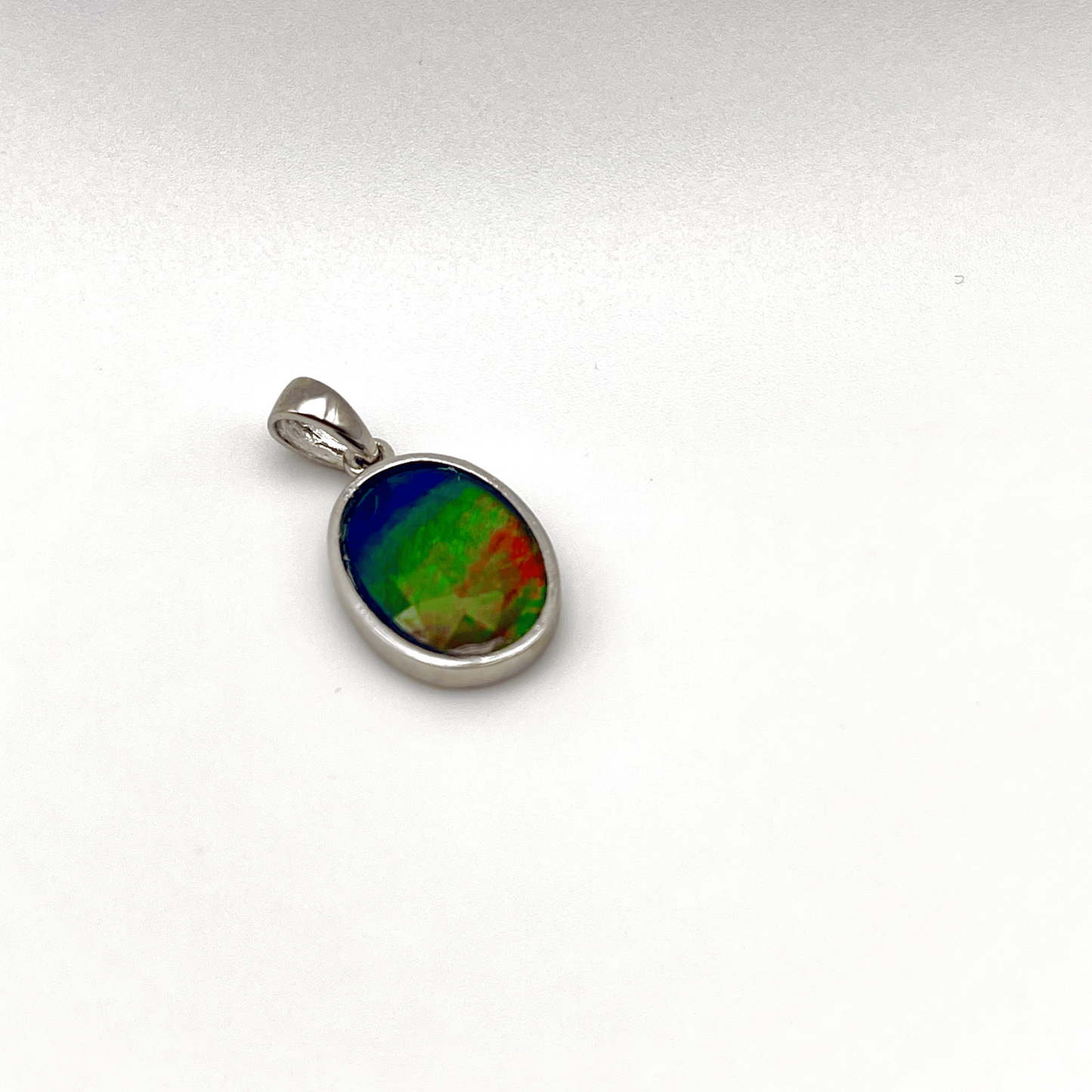 Faceted Oval Ammolite Sterling Silver Pendant featuring a Five Color 10x14 Triplet Gems